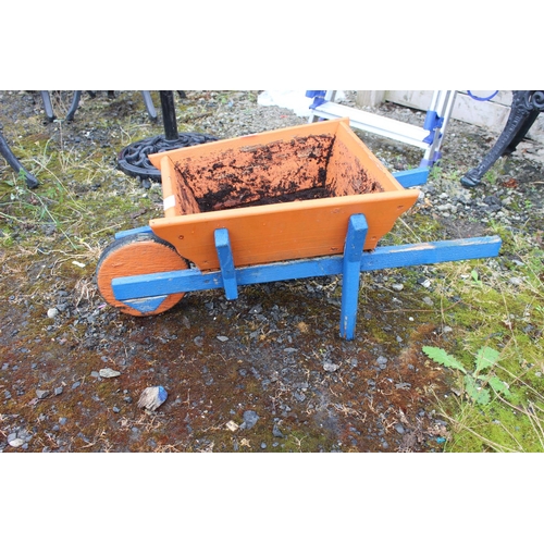 562 - A handmade wheelbarrow planter (a/f).