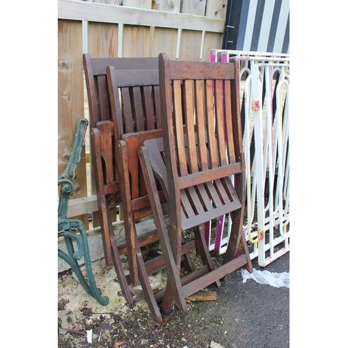 563 - A set of three wooden folding garden chairs.