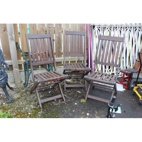 563 - A set of three wooden folding garden chairs.