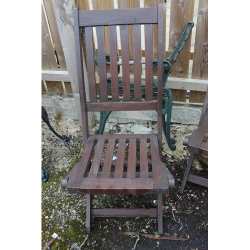 563 - A set of three wooden folding garden chairs.