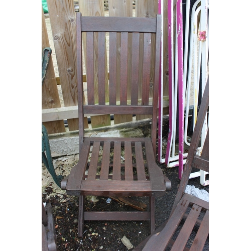 563 - A set of three wooden folding garden chairs.