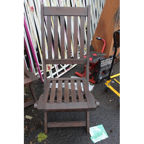 563 - A set of three wooden folding garden chairs.