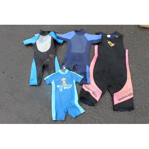 572 - A lot of kid's wetsuits.