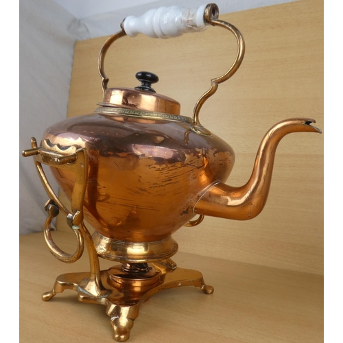 142 - A copper spirit kettle with ceramic handle (a/f).