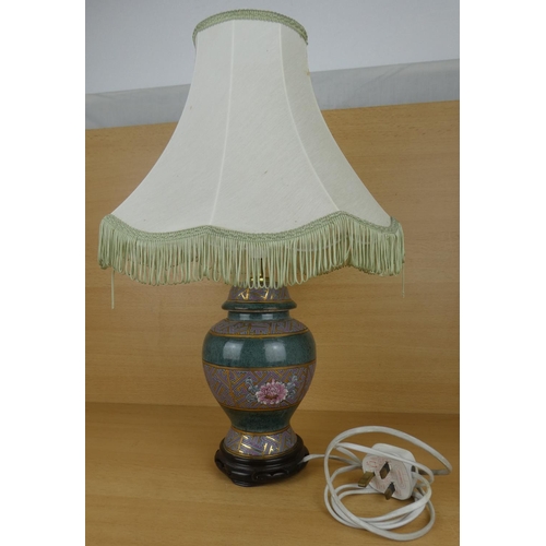 193 - A floral based table lamp and shade.