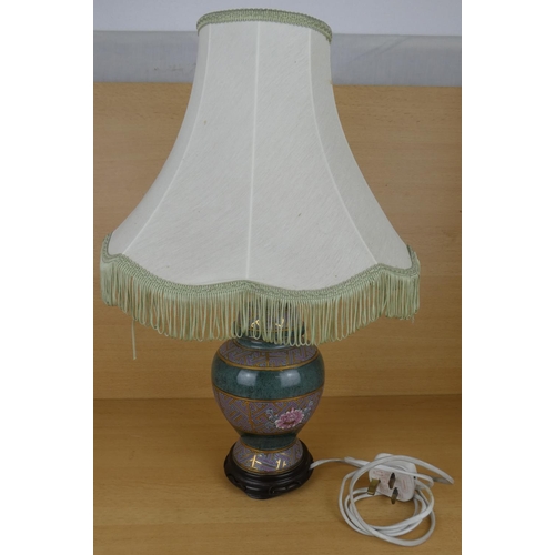 193 - A floral based table lamp and shade.