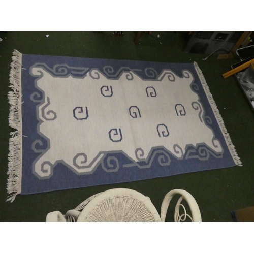 422 - A blue and cream patterned floor rug.