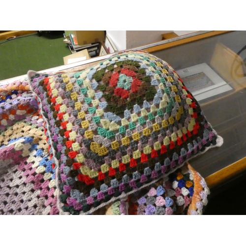 440 - A vintage hand knit blanket and cushion.