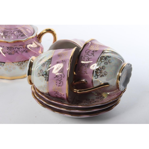 100 - A vintage Roxy China tea set, to include a tea pot, milk jug, sugar bowl, cups and saucers.