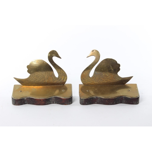 29 - A pair of brass bookends modelled as swans.