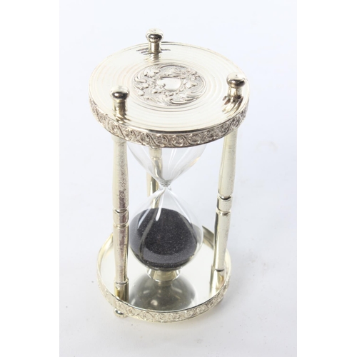 48 - A decorative silver-plated hourglass.