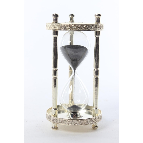 48 - A decorative silver-plated hourglass.