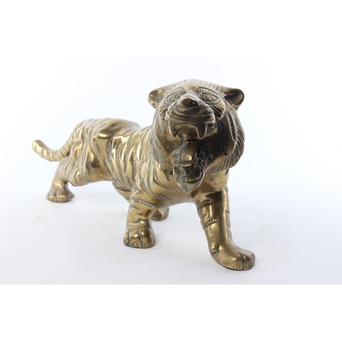 51 - A large brass tiger. Approx  39x18cm.