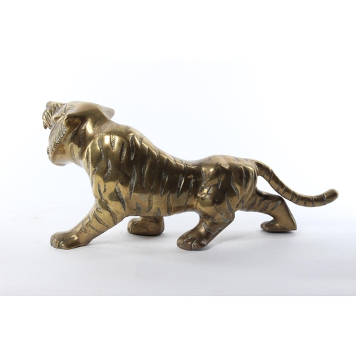 51 - A large brass tiger. Approx  39x18cm.