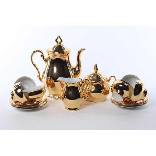 66 - A gold toned tea set, to include a tea pot, milk jug, sugar bowl and more.