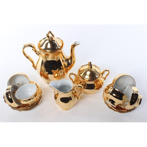 66 - A gold toned tea set, to include a tea pot, milk jug, sugar bowl and more.