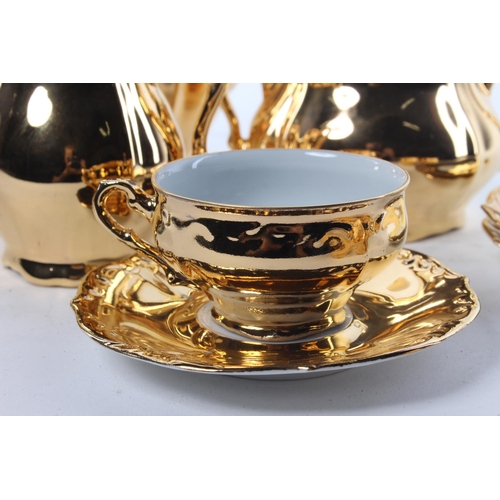 66 - A gold toned tea set, to include a tea pot, milk jug, sugar bowl and more.