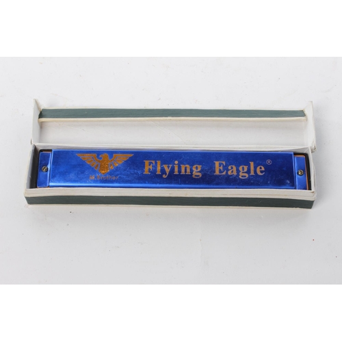 78 - A Flying Eagle harmonica in original card box.