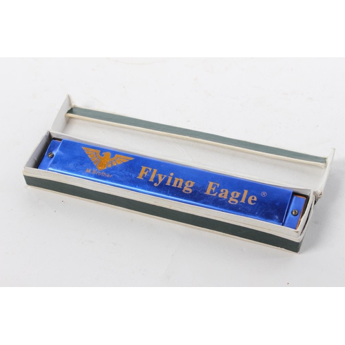 78 - A Flying Eagle harmonica in original card box.