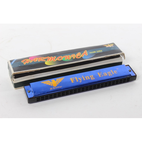 78 - A Flying Eagle harmonica in original card box.