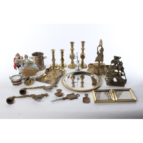 102 - A large assortment of items to include brassware, candlesticks, a ceramic figure and more.