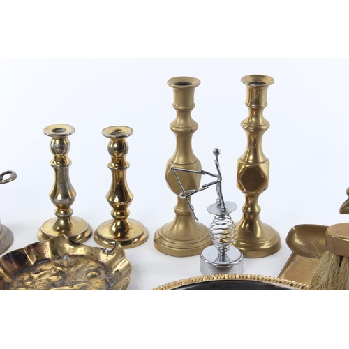 102 - A large assortment of items to include brassware, candlesticks, a ceramic figure and more.