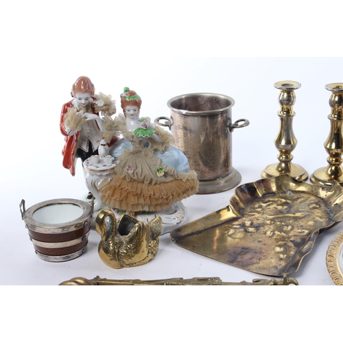 102 - A large assortment of items to include brassware, candlesticks, a ceramic figure and more.