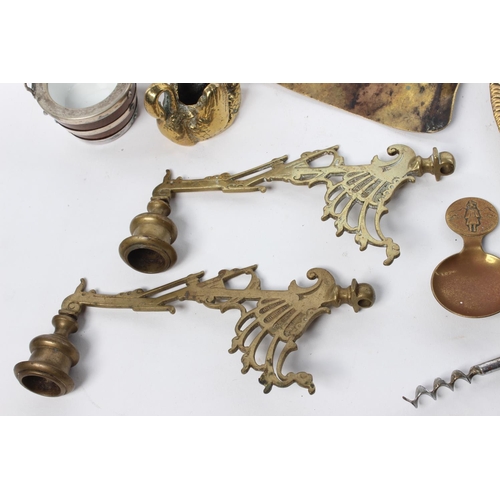 102 - A large assortment of items to include brassware, candlesticks, a ceramic figure and more.