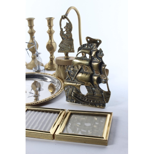 102 - A large assortment of items to include brassware, candlesticks, a ceramic figure and more.