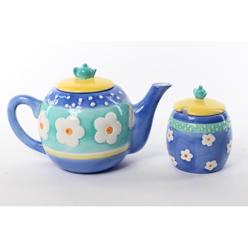 105 - A Rayware ceramic teapot and lidded sugar bowl.