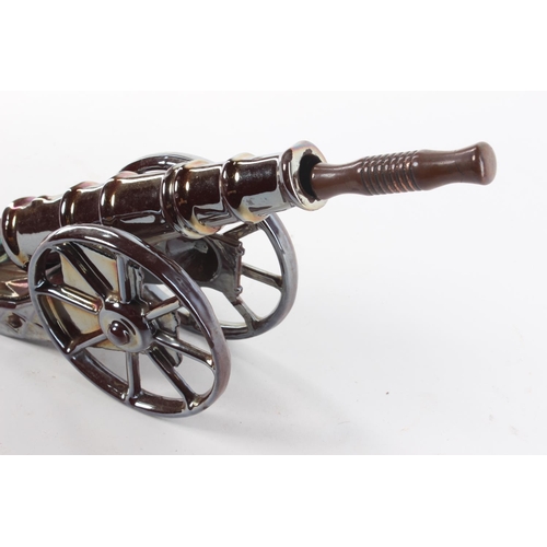 111 - A retro fire poker stand, modelled as a canon. Approx  45cm.