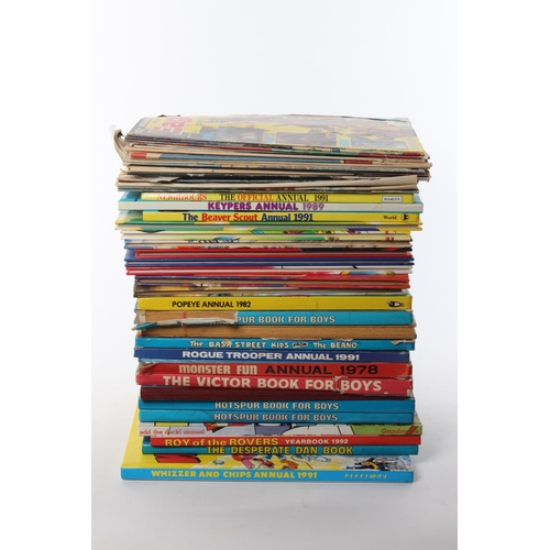 121 - A large assortment of annuals and comics.