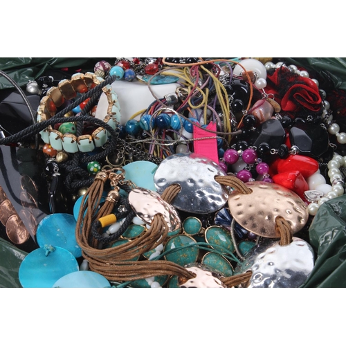 135 - A large assortment of costume jewellery, a hip flask and more.