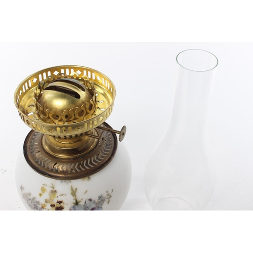 137 - A vintage milk glass oil lamp with hand-painted details.