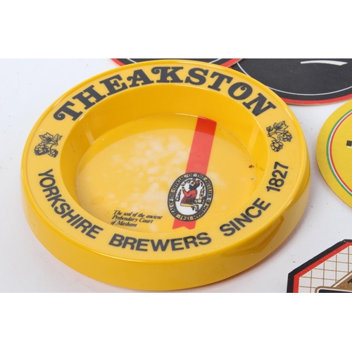 140 - A Theakston plastic ashtray produced by Praesidium Melamine, along with an assortment of beer mats.