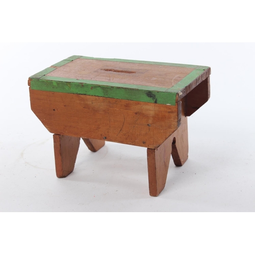 An antique handmade vernacular money box, in the form of a stool.