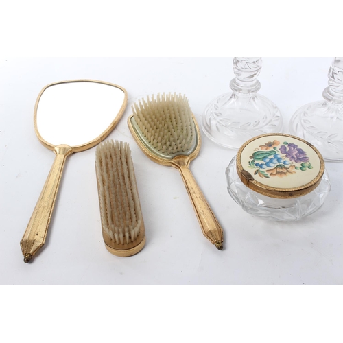 180 - A vintage dressing table set, to include a pair of glass candlesticks, a hand mirror, brush and more... 