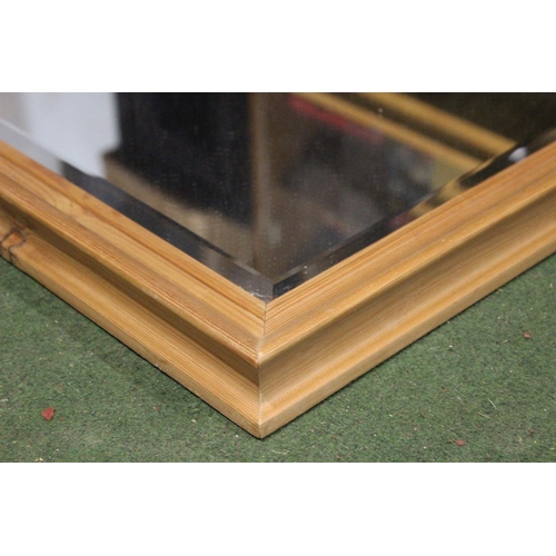 198 - A pine framed bevelled glass mirror. Approx  63x47cm.