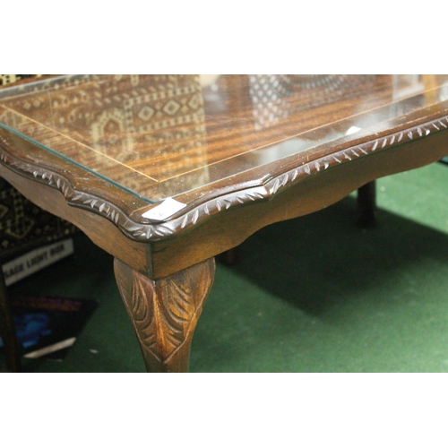 211 - A vintage glass topped coffee table.