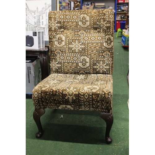 212 - A vintage nursing chair with decorative upholstery.