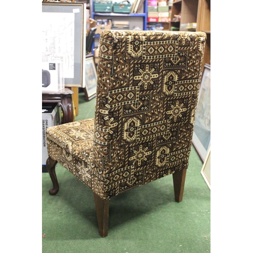 212 - A vintage nursing chair with decorative upholstery.