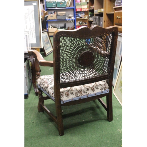 216 - A vintage chair with decorative woven back.