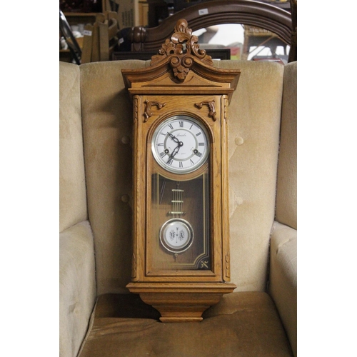 220 - A Lincoln wood cased 31 day regulating wall clock. Approx  70cm.