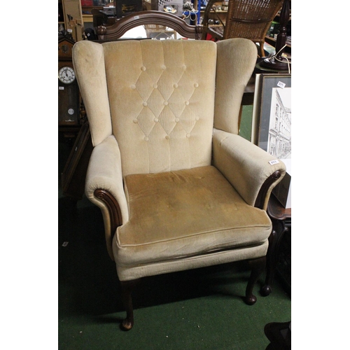 222 - A vintage wingback armchair.