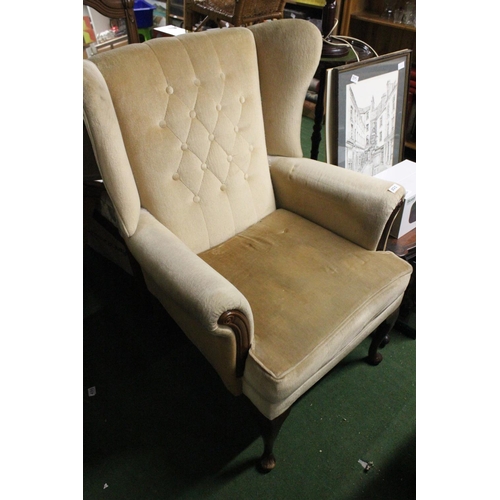 222 - A vintage wingback armchair.