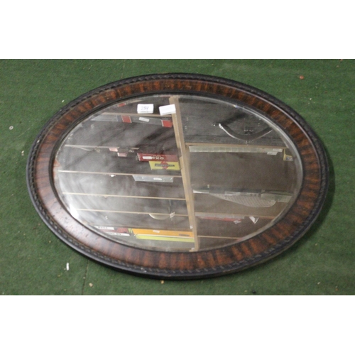 239 - A wood framed bevelled glass mirror.