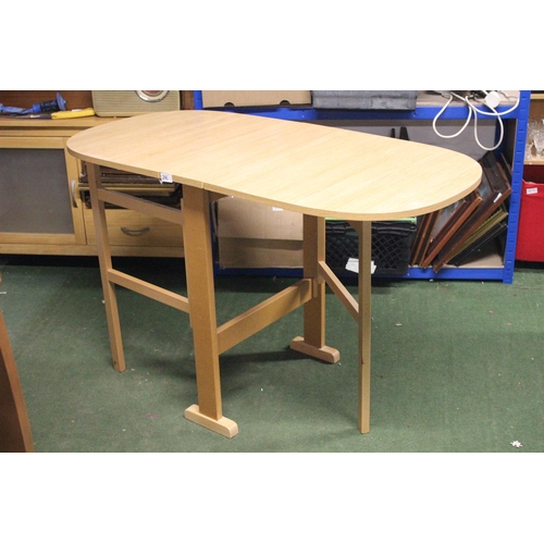 246 - A drop leaf dining table.