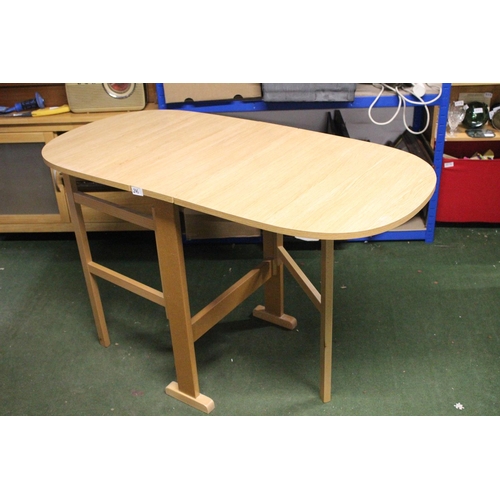 246 - A drop leaf dining table.