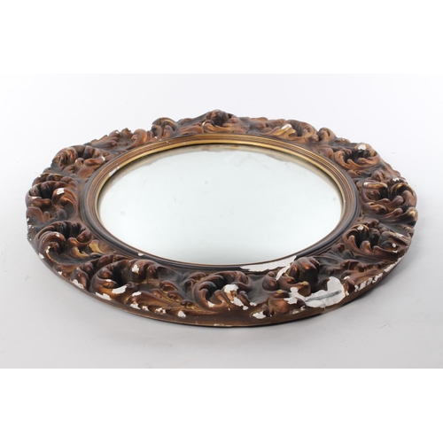 252 - A vintage/ retro wall mirror with decorative plaster frame.