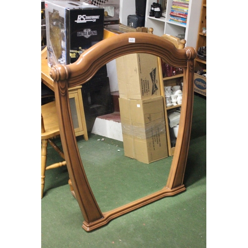 263 - A large decorative mirror in wood effect frame. Approx 106x92cm.